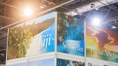 Signs for Seychelles, Fiji and Papua New Guinea at the ITC booth for the Professional Beauty trade show
