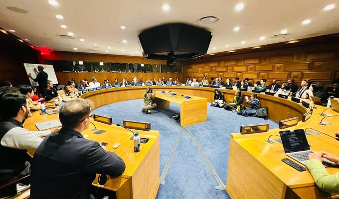 Wide shot of UN conference room hosting a youth forum