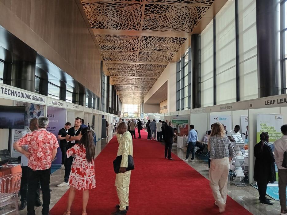Conference hall with red carpet lined with booths