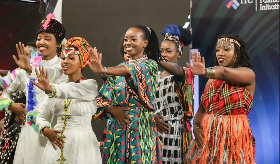 Kenyan group sings and dances in contemporary African dress on stage for reality show