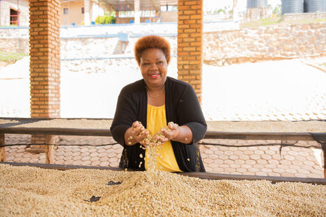 Nova Coffee Rwanda single woman with beans