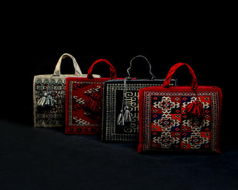 Hand woven bags against a dark background