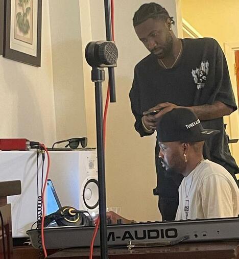 Two men by microphone edit songs