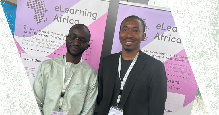 Two men stand in front of eLearning Africa banner