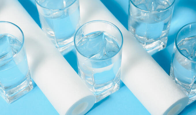 Water filters lie next to clear glasses of water