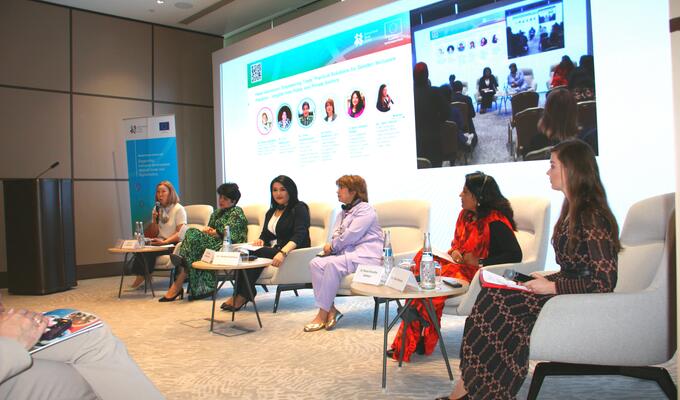 Panel of women sit on white chairs to discuss trade in Central Asia