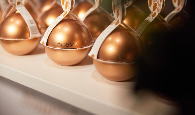 Close-up showing rows of metallic balls contained coconut-based beauty products