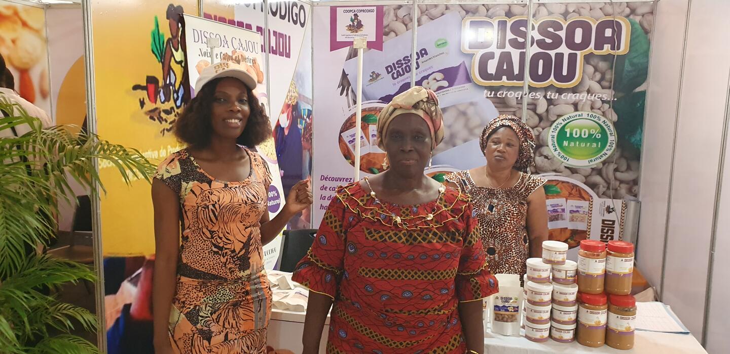 Two women at a cashew booth in Abidjan