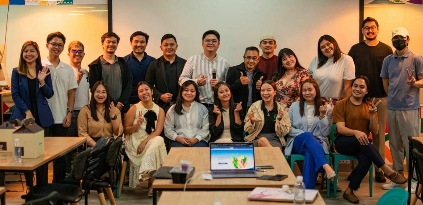 Group of young Filipino entrepreneurs pose for group photo in workshop room