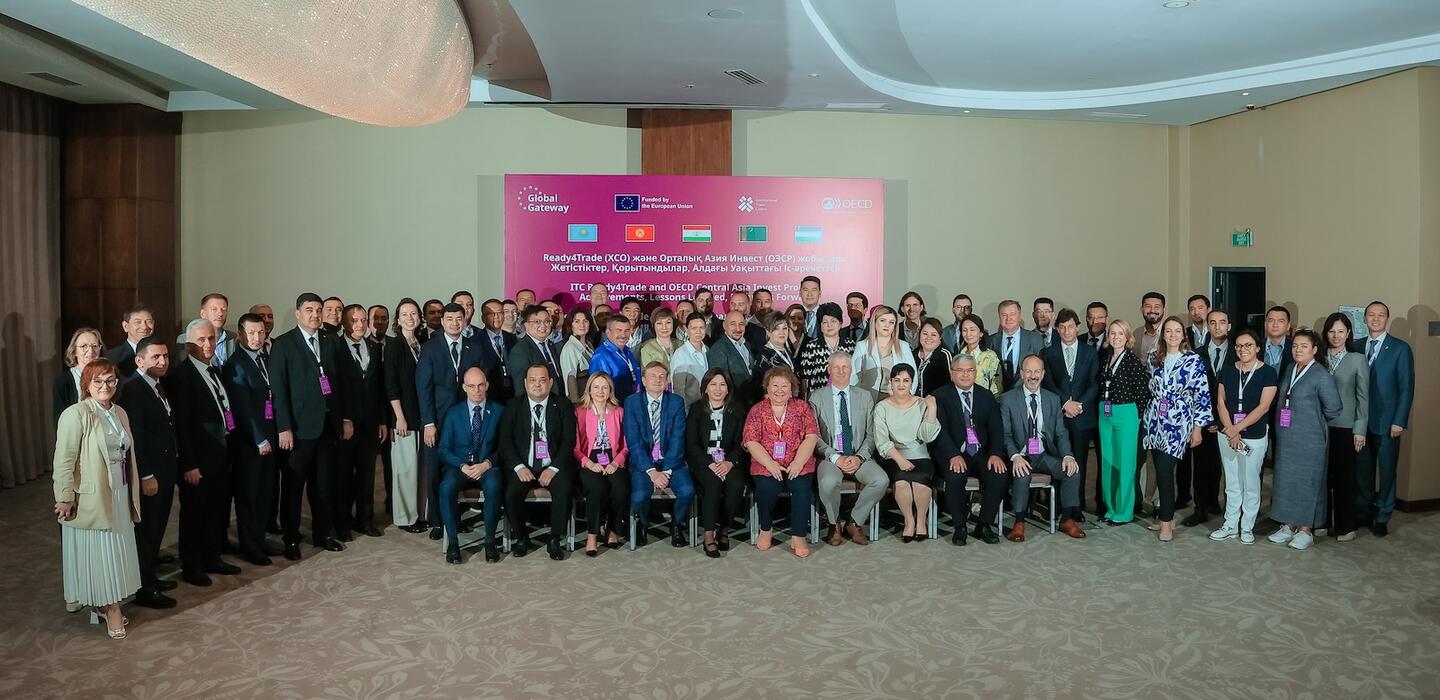 Large group of trade experts and business leaders pose in conference room