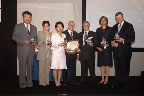 ITC, Malta Enterprise and Award winners standing on the podium with the awards in their hands